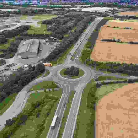 ariel shot of a logistics site next to a main road and farmland